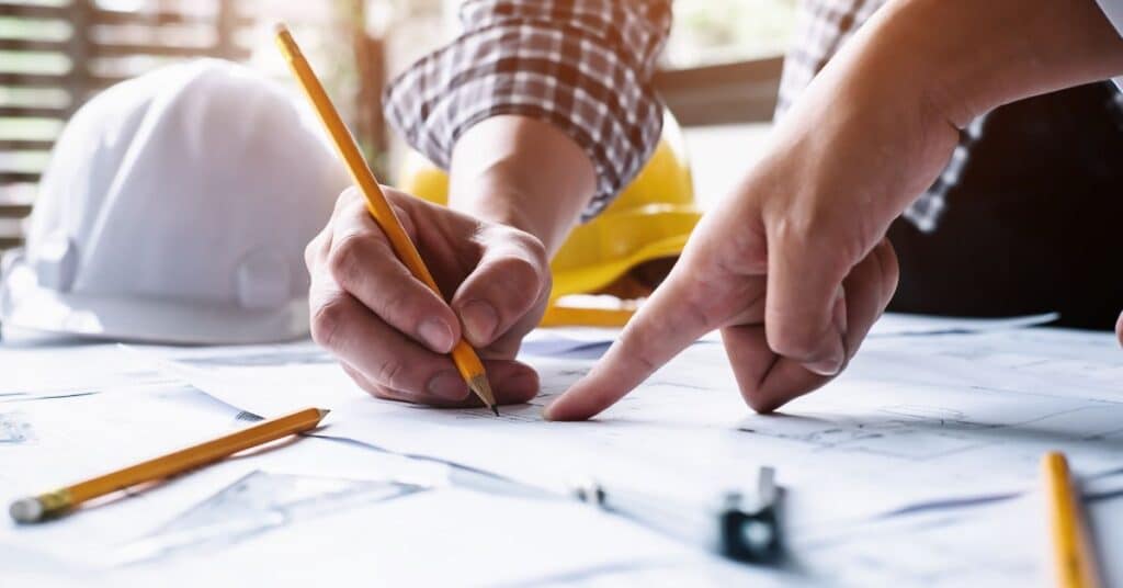 Two oil and gas specialists reviewing design specs