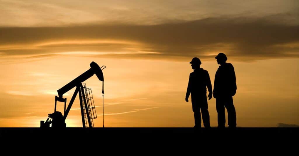 Two workers at an oil and gas facility
