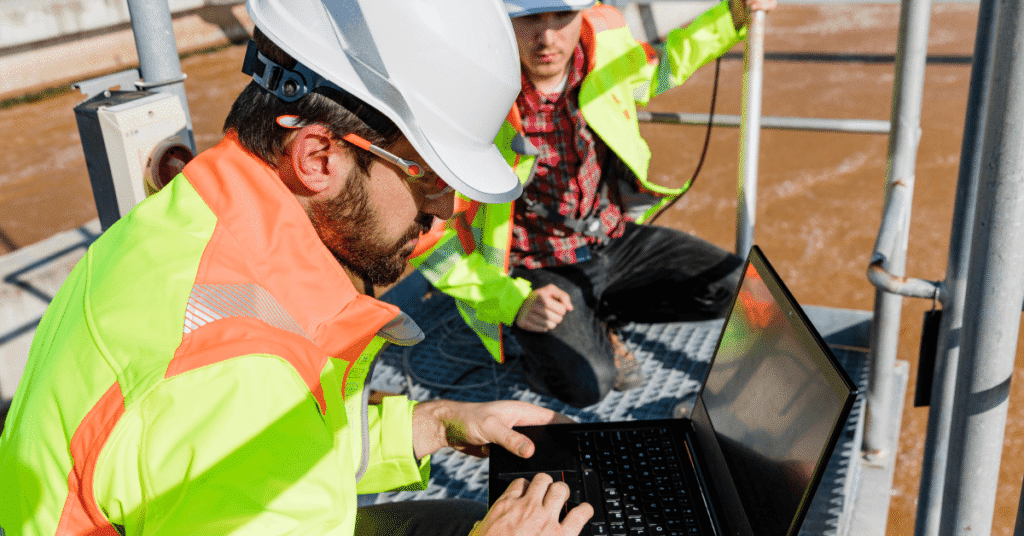 Two men completing oil and gas equipment diagnostics